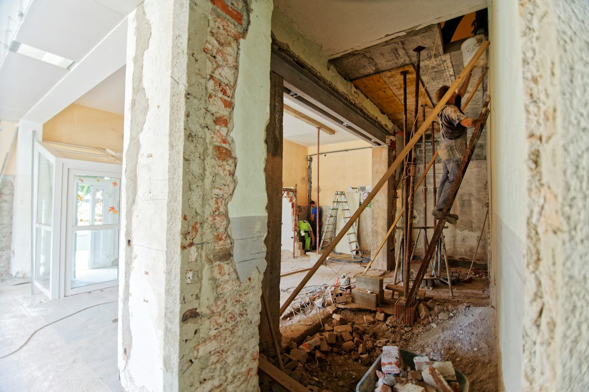 Home under renovation with open walls and a ladder