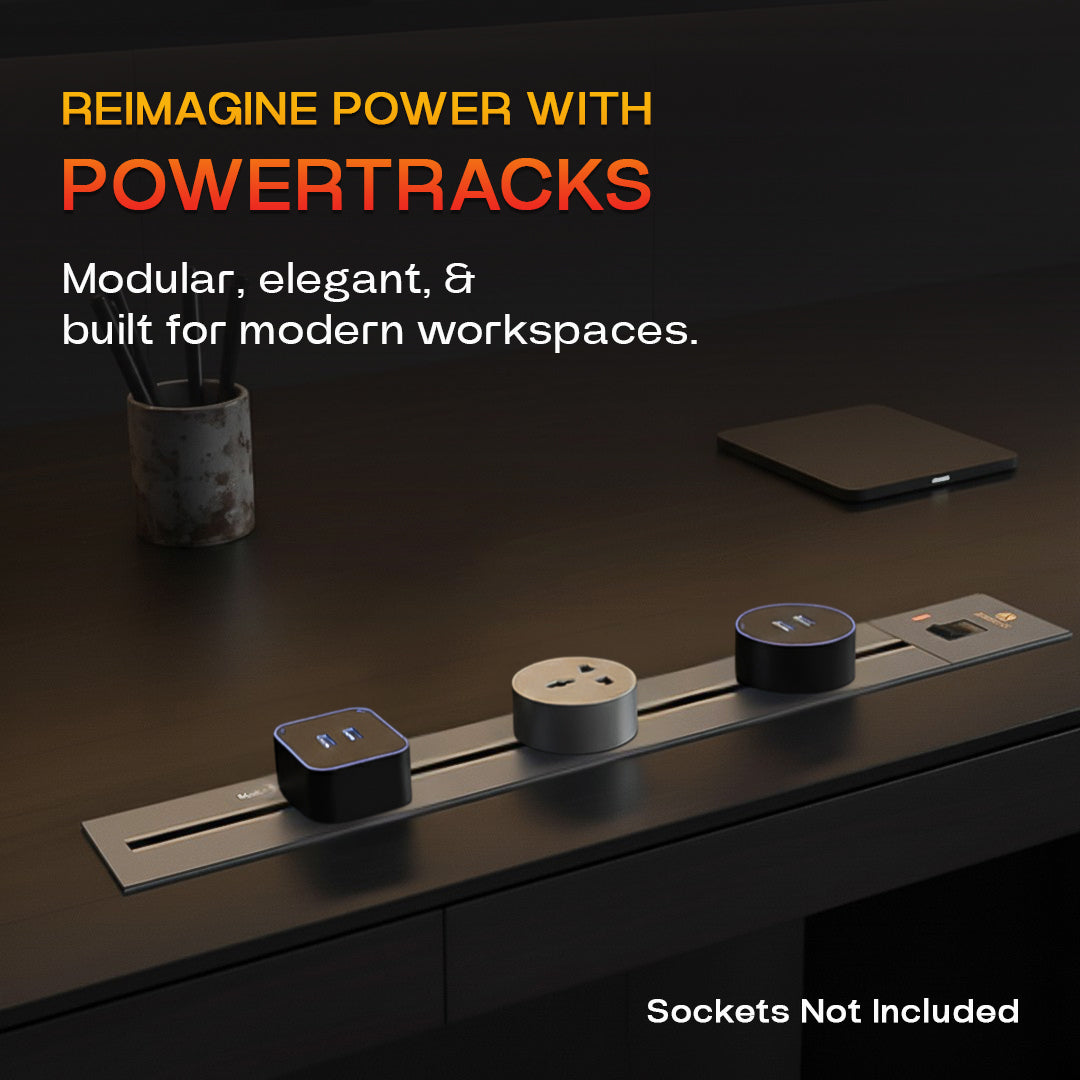 Concealed power track set flush into a dark desk with three sockets along it (sockets not included)
