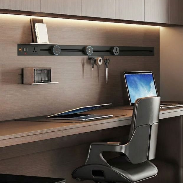 Concealed track recessed into the panelling above a study desk, with sockets spaced along it